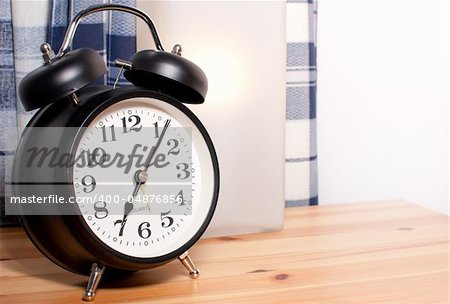 Alarm Clock and Reading Lamp on Bedside Table
