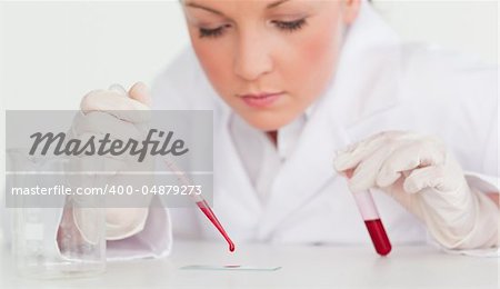 Beautiful female scientist holding a test tube in a lab