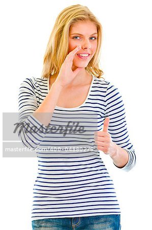 Smiling beautiful teen girl reporting good news and  showing thumbs up gesture isolated on white