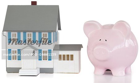 House and piggy bank against a white background