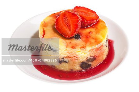 Cheesecake with fresh strawberries on white plate closeup