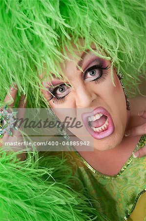 Shocked drag queen in boa wig close-up