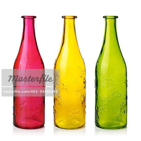 Three empty colorfull glass bottles.  Isolated on white