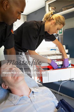 Paramedics with patient in ambulance