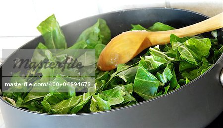 Preparing spinach, cutting green fresh leaves for cooking