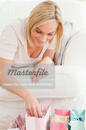 Close up of a woman looking in her shopping bags in her living room