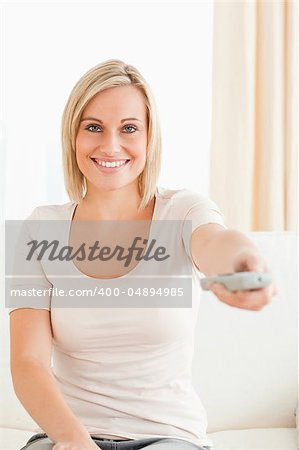 Portrait of a lovely woman watching television in her living room