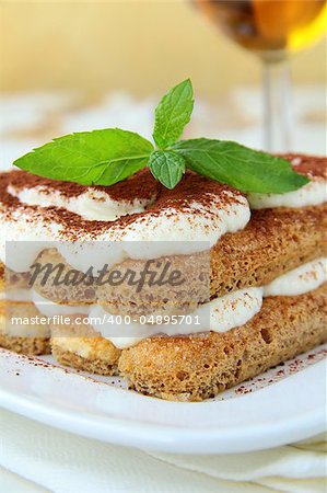 Traditional Italian dessert tiramisu on white plate