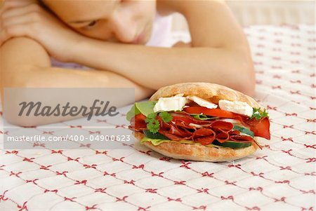 hungry girl hands teen girl by appetizing big sandwich with ham and cheese