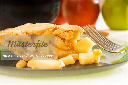 fresh homemade apple pie over green glass dish macro close up eating  with fork