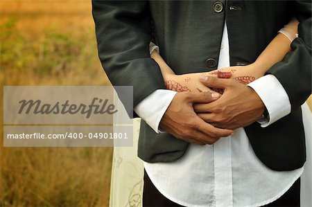 Close-up of a bride and groom in an embrace.