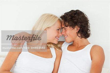 In love couple looking at each other in their bedroom
