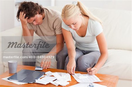 Worn out couple working together in the living room