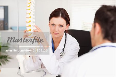 A female doctor is touching a spine