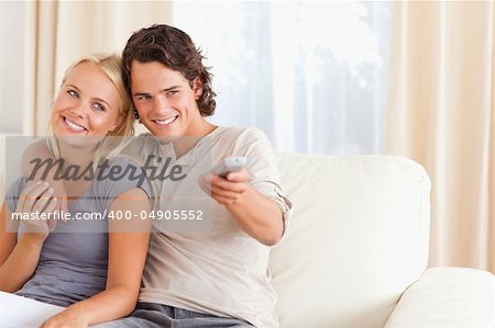 Couple watching TV in their living room