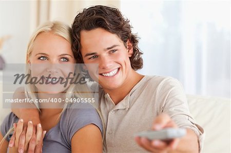 Close up of a couple watching TV in their living room