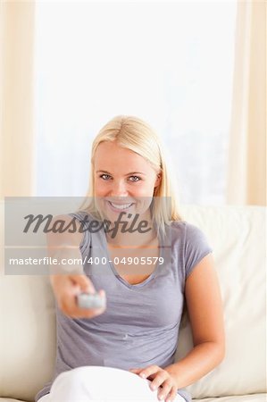Woman using a remote in her living room