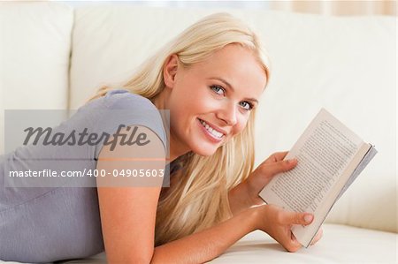 Woman holding a book in her living room