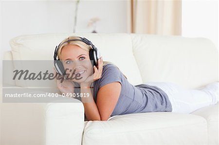 Blonde woman listening to music in her living room