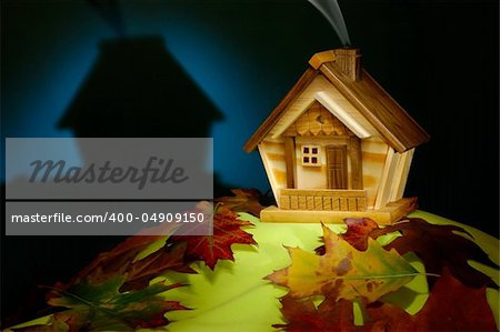 Wooden house on a hill covered with fallen autumn leaves nighttime scenic artistic still life