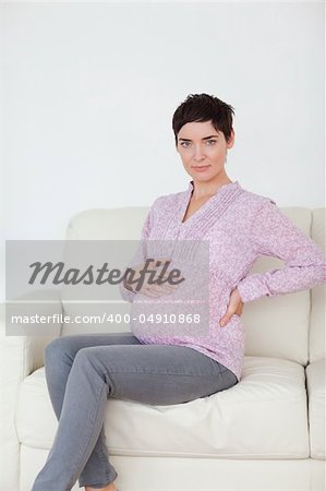 Pregnant woman sitting on a sofa in a waiting room