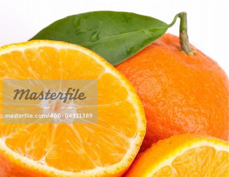 Tangerines with green leaves isolated on white.