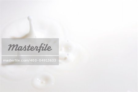 drop of milk splashes into fresh milk