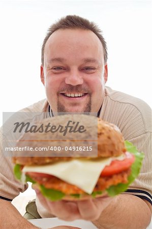 Man happy with the size of his hamburger holding it happily - closeup, isolated