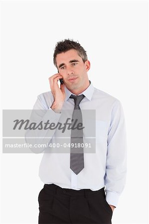 Portrait of a businessman making a phone call against a white background