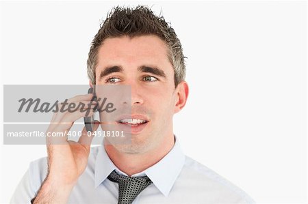 Close up of a businessman making a phone call against a white background