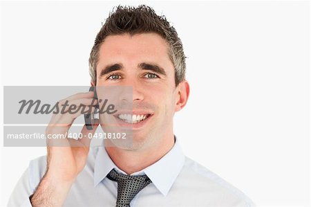 Close up of a happy businessman making a phone call against a white background