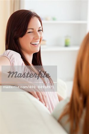 Smiling women relaxing on a sofa in a living room