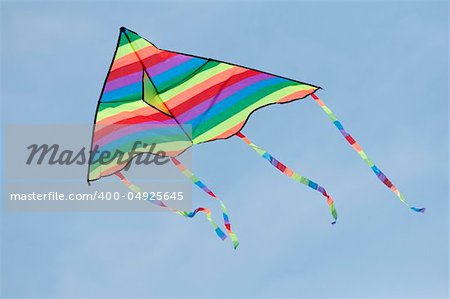 Multicolored kite on blue sky background