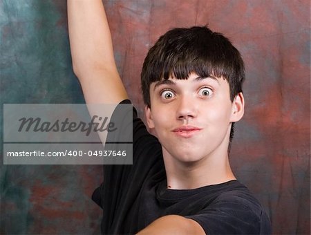 astonished young teenager, lifted arms