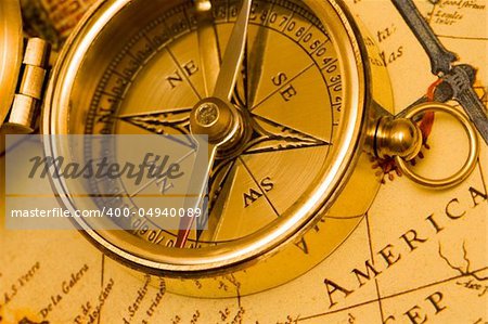 Old style brass compass on antique  map