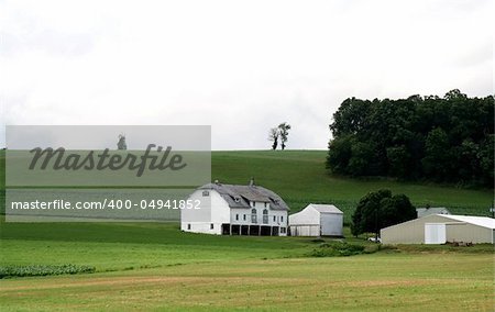 Farm House with Barn on Hill and Open Green Field