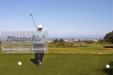 Golfer playing golf on the tee box. Copy space.