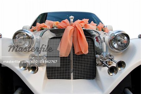 The wedding limousine decorated by tapes and colors expects the groom and the bride for walk