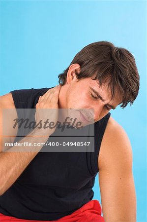 portrait of a young man having a headache over blue background