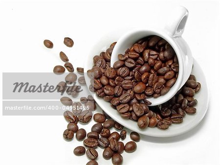 Fresh coffee beans and ceramic coffee cup