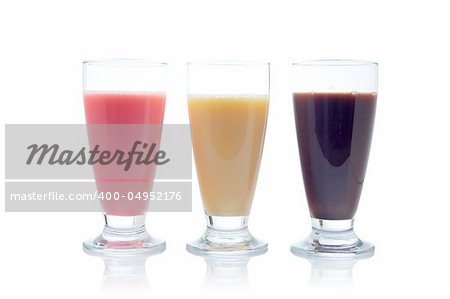 A three milkshakes with flavors of strawberry, vanilla and chocolate reflected on white background