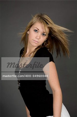 Teenage girl posing on gray background with some attitude