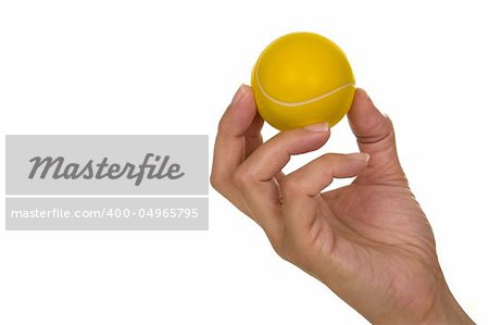 Feminine hand holding miniaturized rubber tennis ball over white background