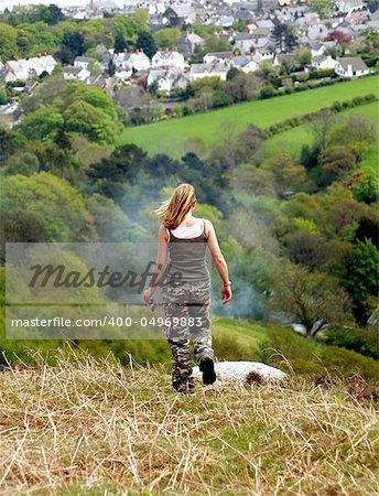 A female hiker descending conwy mountain towards conwy in snowdonia, north wales. A female hiker descending conwy mountain towards conwy in snowdonia, north wales.