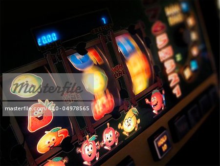 slot machine wheels spinning, reels brightly lit, differential focus