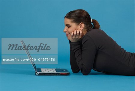 Pretty young businesswoman with notebook, working