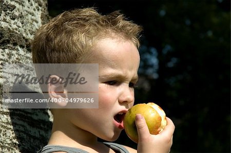 Kid going to take a bite off an apple