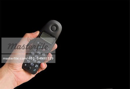 Hand holding a phone in a black background