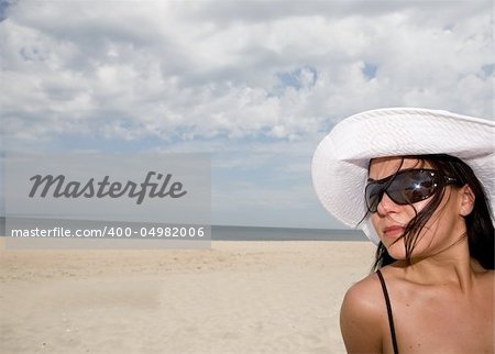 attractive brunette woman relaxing on beach