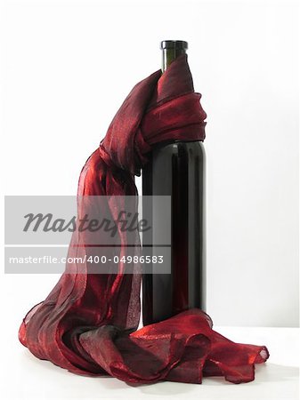 Wine bottle and  red scarf on a white background